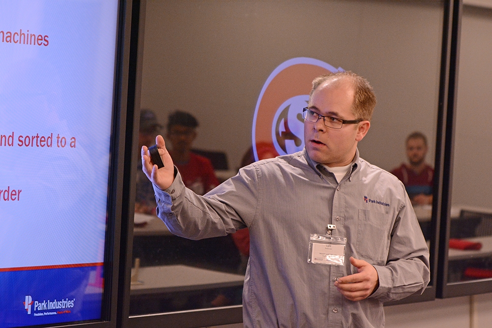 Lyle Pedersen points at a screen
